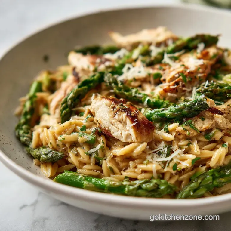 Elegant plate of orzo: juicy chicken slices atop glistening pasta, bright asparagus spears, and a rich, creamy parmesan sa...