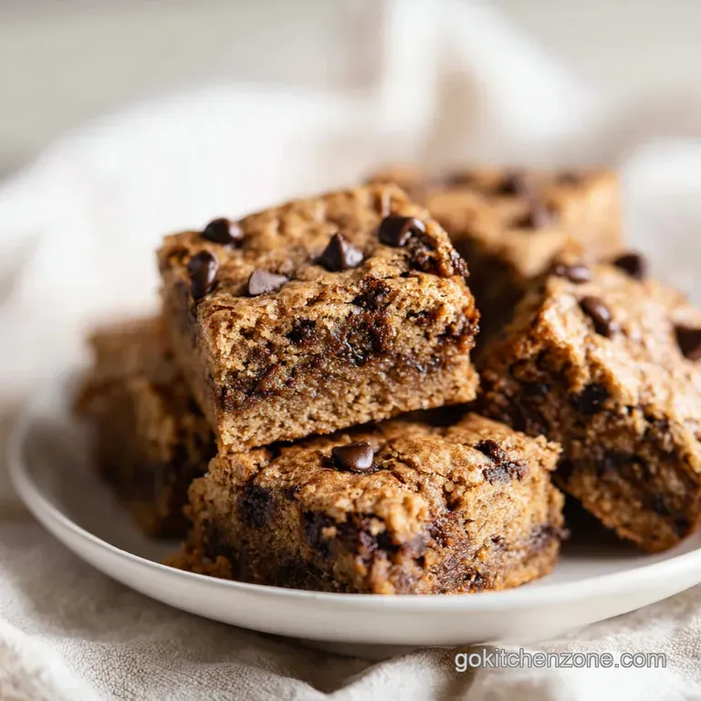 Warm, fudgy blondie squares artfully arranged with a dusting of powdered sugar.
