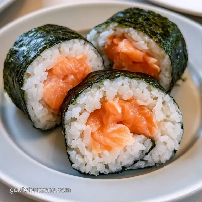 Neatly arranged white rice balls and flaky pink salmon in a wooden box with bright green broccoli and orange carrots.